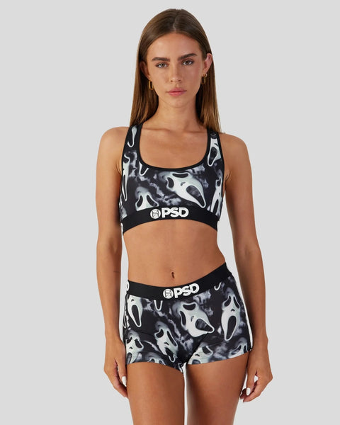 Black and white ghost face print sports bra and shorts set with PSD branding.