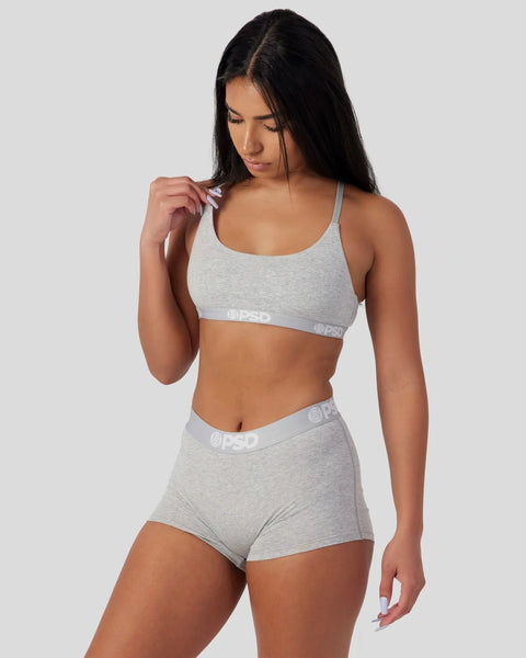Light grey sports bra and boy short set with branded elastic waistband and straps.