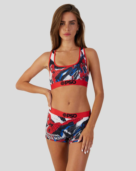 Woman wearing a red, blue and white Spider-Man sports bra and matching shorts with PSD branding.