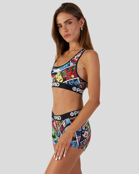Woman wearing Marvel Comics-themed sports bra and shorts with colorful comic book panels and PSD branding.
