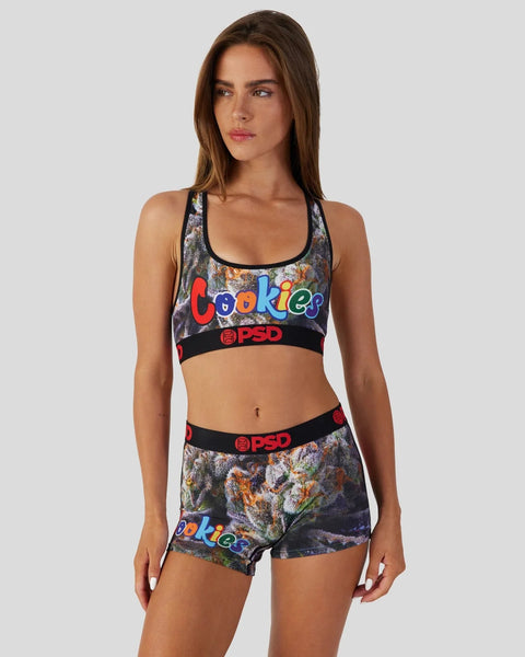 Woman wearing a floral-patterned sports bra and matching shorts with colorful 