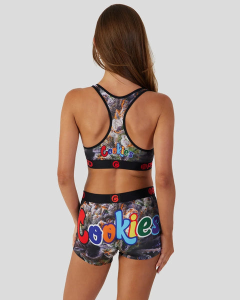 Woman wearing a black sports bra and shorts set with colorful 