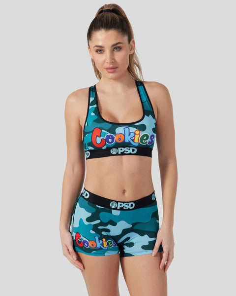 Woman wearing blue camouflage sports bra and shorts set with 