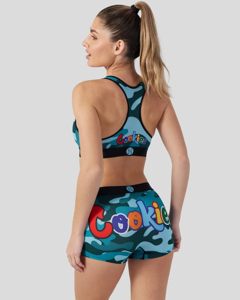 Woman wearing blue camouflage sports bra and shorts with colorful 
