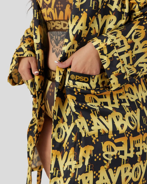 Black and gold graffiti-patterned two-piece set with cropped top and matching bottoms featuring PSD branding.