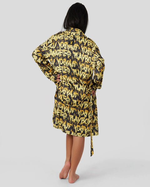 Black and gold graffiti-print robe with text pattern, shown from back on model.
