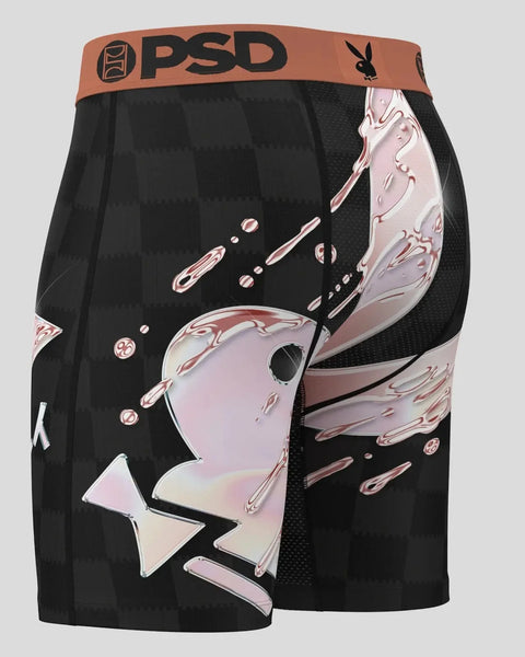 Black boxer briefs with rose-shaped graphic and dripping design, orange PSD waistband with Playboy logo.