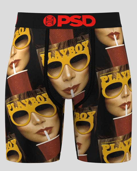 Black boxer briefs with red PSD waistband featuring repeated Playboy magazine cover imagery with yellow sunglasses and cigare