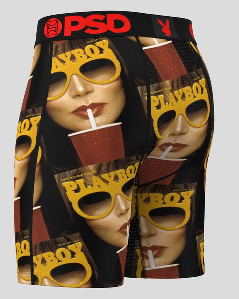 Black PSD boxer shorts with repeated Playboy magazine cover imagery and yellow sunglasses print throughout.