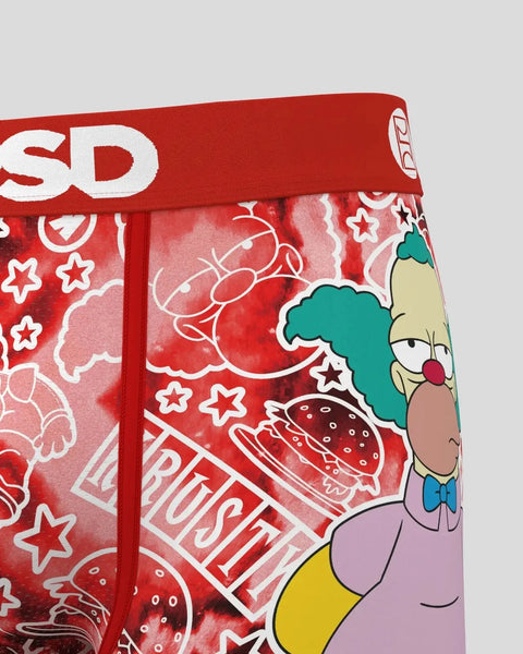 Krusty the Clown character with turquoise hair, red nose, and purple outfit on red fabric with stars and burger patterns.