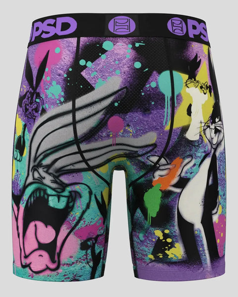 PSD brand boxer briefs with Bugs Bunny character design in purple, black, and multicolor splatter pattern.