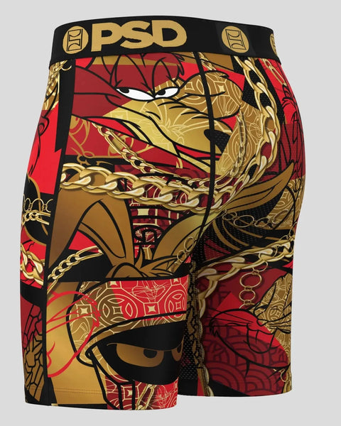 PSD brand black shorts with red and gold Looney Tunes character graphic print and elastic waistband.