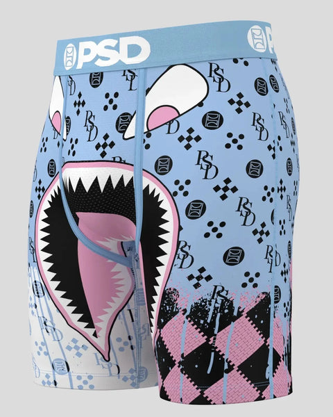 Light blue boxer shorts with PSD waistband, featuring monster mouth graphic with sharp teeth, pink interior, black spikes, an
