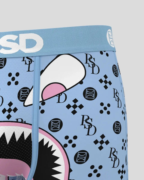 Light blue briefs with pink and black cartoon face graphic, RSD branding, and geometric patterns throughout.