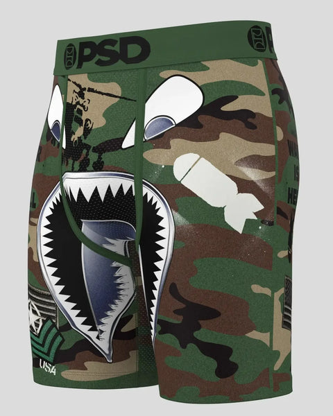 Men's boxer shorts with green, tan, and brown camouflage pattern and graphic shark mouth design on front.