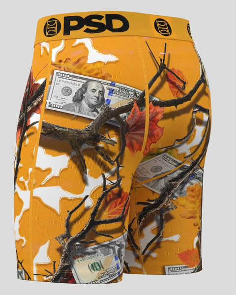 Orange PSD boxer shorts with pumpkin, branch, and hundred dollar bill graphic print throughout.