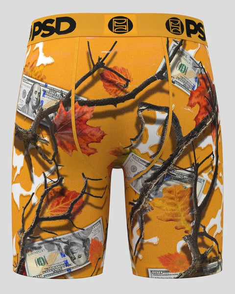 PSD brand gold boxer shorts with red and orange autumn leaves, black branches, and dollar bill graphics throughout.