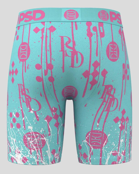 Turquoise boxer briefs with magenta abstract graphics, PSD brand waistband, and white splatter accents.