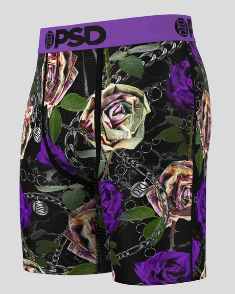 Black shorts with purple, pink, and cream roses, green leaves, and chain link pattern throughout, purple PSD waistband.