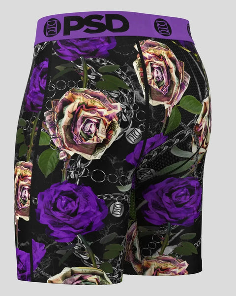 Black shorts with purple and faded rose floral pattern and purple PSD waistband.