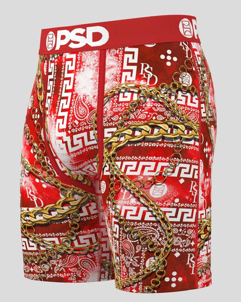 Red PSD boxer briefs with paisley, geometric, and gold chain print throughout.
