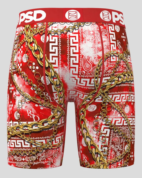 Red shorts with gold chain and paisley pattern print, white geometric designs, and PSD waistband.