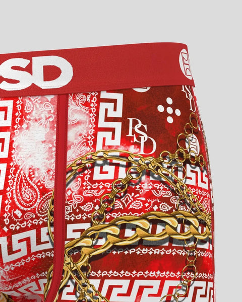 Red underwear with white paisley and geometric patterns, gold chain design, and PSD waistband.
