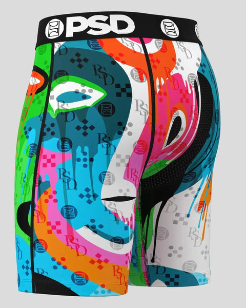 PSD boxer briefs with black waistband featuring multicolored abstract face design in green, pink, orange, teal, and white.