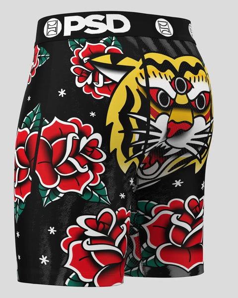 PSD black shorts with yellow three-eyed cat face and red rose tattoo-style graphics.