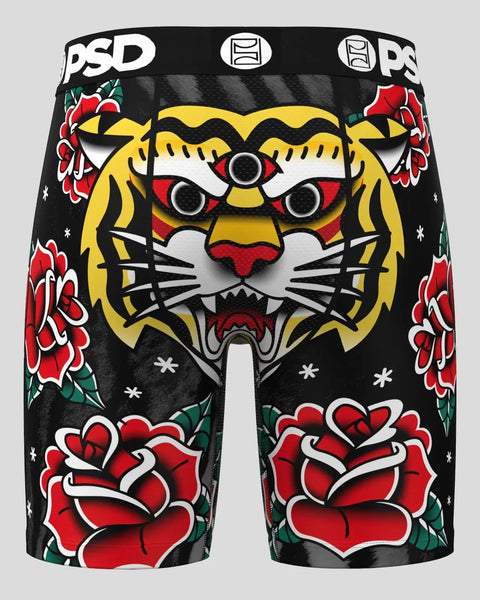 Black shorts featuring a three-eyed tiger face with yellow and red details, surrounded by red roses and small white stars.