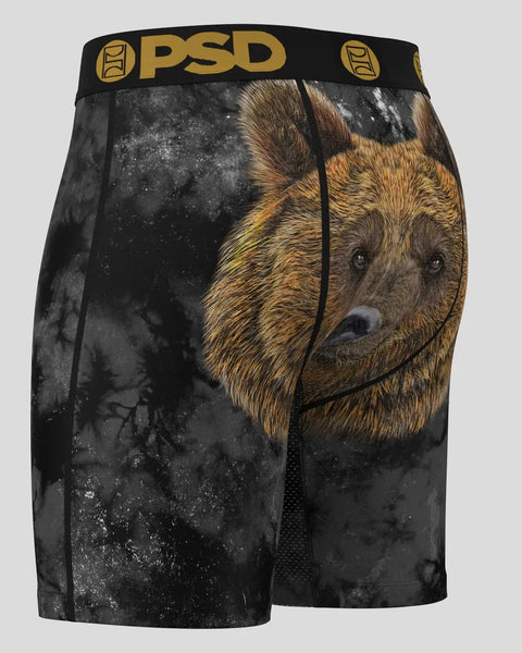 Black PSD shorts with brown bear head graphic and distressed texture on dark background.