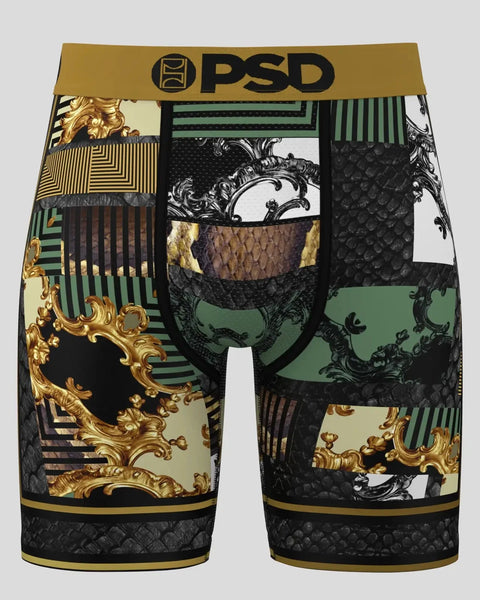 PSD brand boxer briefs with patchwork design featuring black scale texture, gold ornamental motifs, green and cream panels, a