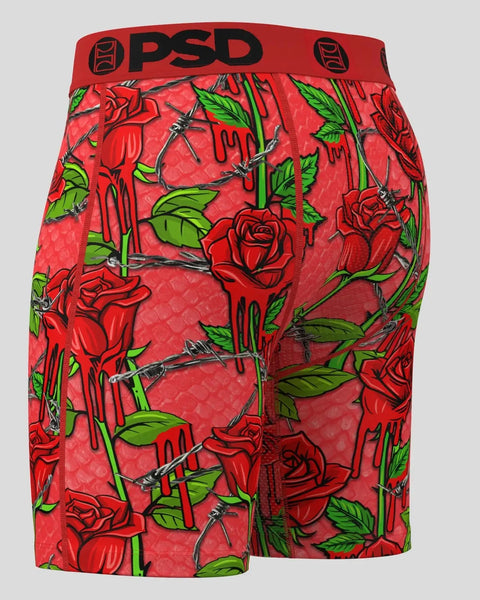 Red PSD shorts with red roses, green leaves, and black thorns throughout, red waistband with PSD logo.