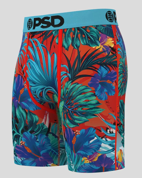 PSD brand boxer shorts with turquoise waistband featuring vibrant tropical floral pattern in red, blue, purple, and green.