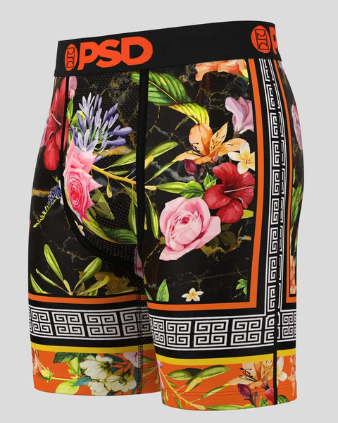 PSD boxer briefs with black base, multicolored floral print, orange waistband, and geometric stripe pattern on legs.