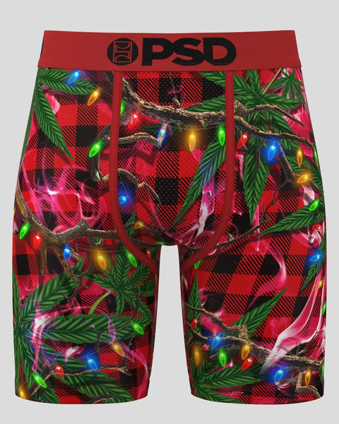 PSD brand boxer shorts with red buffalo plaid, green pine branches, and multicolored Christmas lights pattern.