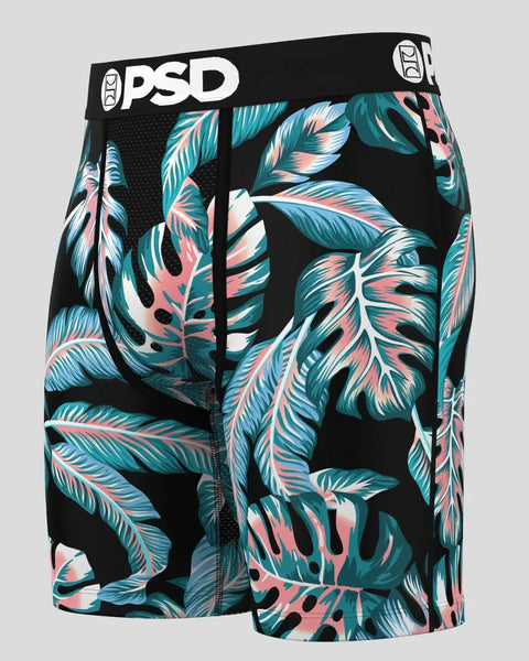 PSD men's boxer briefs with tropical leaf pattern in teal, pink, and white on black background.