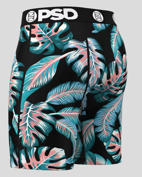 PSD brand shorts with black waistband and tropical leaf pattern in teal, coral, and white.