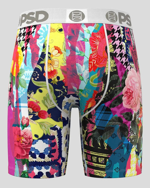 Colorful patchwork boxer briefs with mixed floral, houndstooth, and geometric patterns in pink, yellow, navy, and teal.