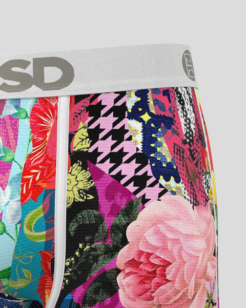 Stack of colorful fabric swatches with floral, geometric, and patterned designs in pink, black, yellow, and multicolor tones.