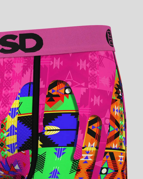 Bright pink swim shorts with tribal-inspired geometric patterns in blue, green, orange, and black, featuring 