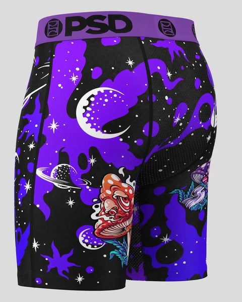 PSD boxer shorts with purple and black space-themed print featuring mushrooms, moons, stars, and planets on black background.