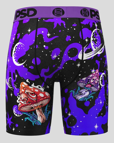 PSD brand black shorts with purple waistband featuring colorful mushroom and space-themed graphics with stars and planets.