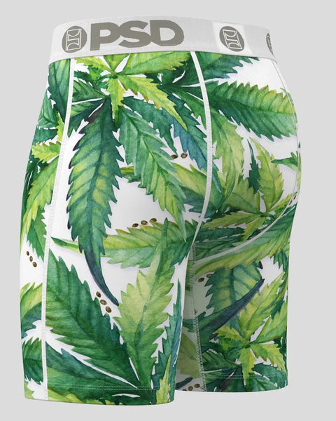 PSD boxer shorts with green and yellow leaf print and white waistband on gray background.