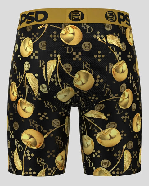 Black shorts with gold cherry and leaf pattern, PSD brand waistband, back view.