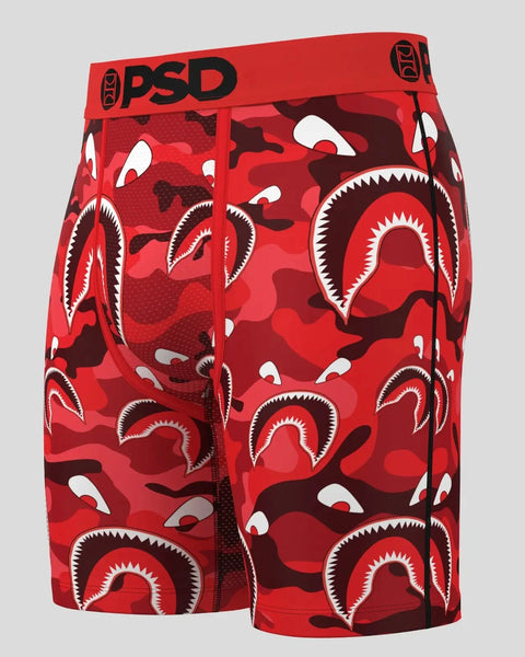Three red and dark red camouflage boxer briefs with white shark mouth graphics and PSD branding on waistband.