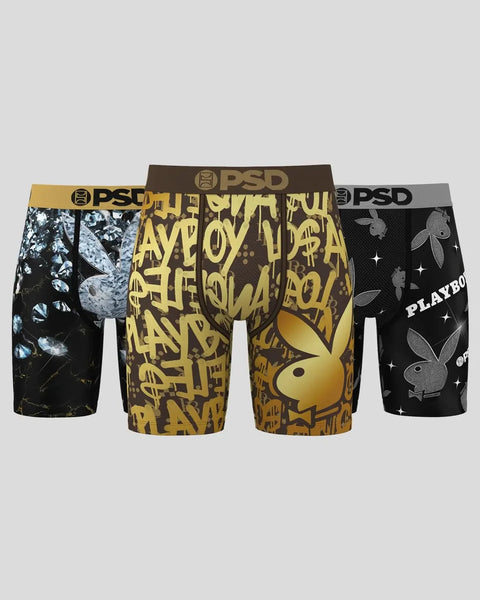 Three Playboy Lux boxer briefs in black and gold with floral and logo patterns, featuring PSD waistbands.