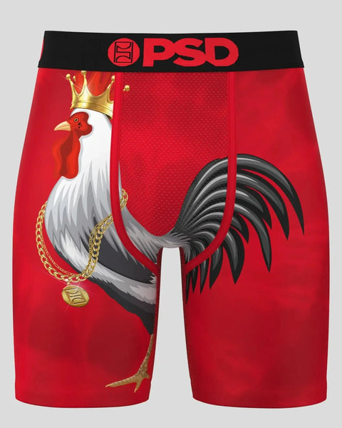 Red PSD brand shorts with rooster graphic wearing gold crown and chain necklace on front.