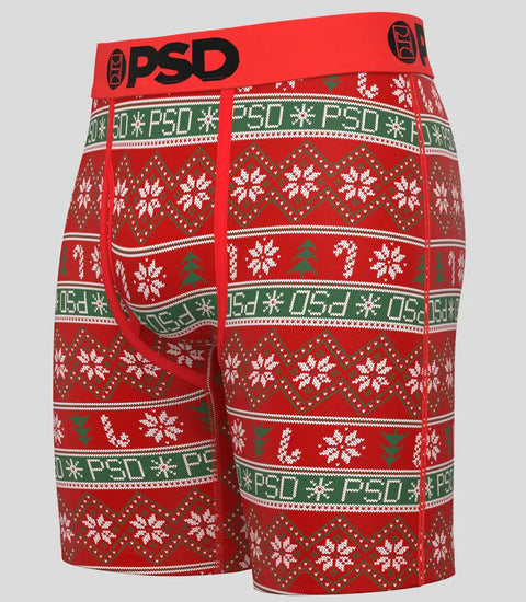 Red boxer briefs with white snowflakes, green trees, and "PSD" text in holiday knit pattern design.