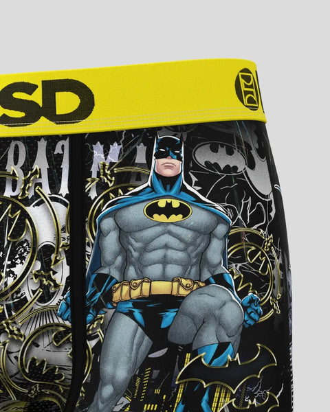 Batman character in blue and gray suit with yellow belt on black fabric with yellow waistband.